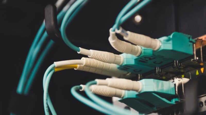 Detailed view of fiber optic cables and ports in a server room, showcasing connectivity. - Photo by Brett Sayles on Pexels