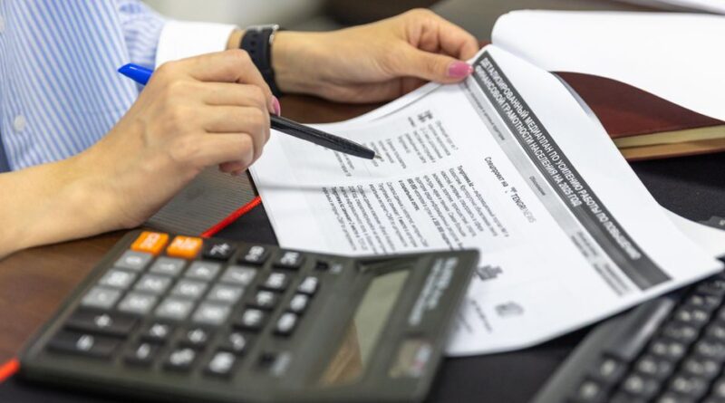 Close-up of a person analyzing financial documents using a calculator and pen. - Photo by Bia Limova on Pexels