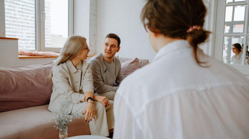 A couple engaged in a counseling session with a therapist in a modern indoor setting. - Photo by Polina Zimmerman on Pexels