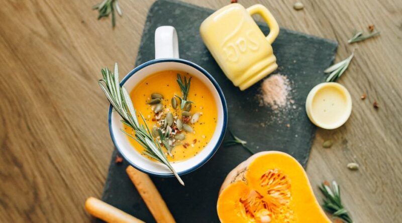 Scrumptious homemade pumpkin soup garnished with herbs, perfect for a cozy meal. - Photo by Nataliya Vaitkevich on Pexels