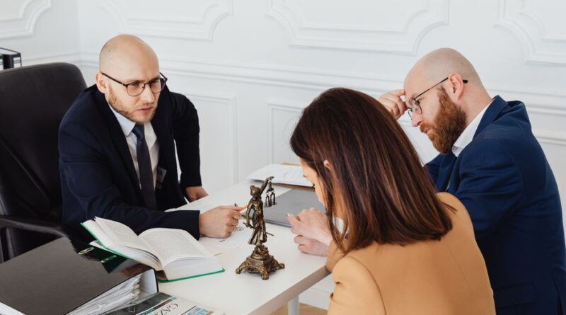 Lawyer consulting clients in a modern office setting, serious discussion. - Photo by https://kaboompics.com/ on Pexels
